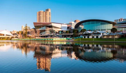 Adelaide Convention Centre viewed from the north side of Torrens river in Elder Park.